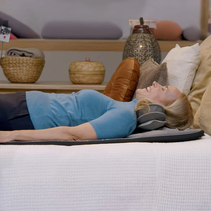 user relaxing on dr-ho’s motion solution mat at home